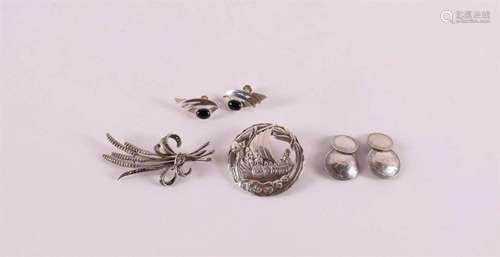 A lot of silver jewelry, including a Viking ship brooch.