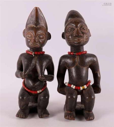 A set of tropical wooden fertility statues, man and woman, A...