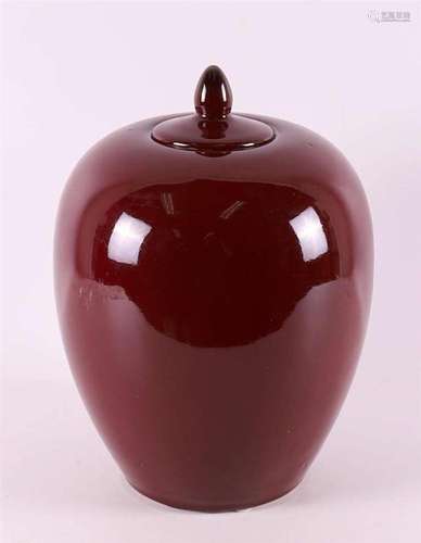 A spherical red glazed 'Sang de Boeuf' vase with lid...