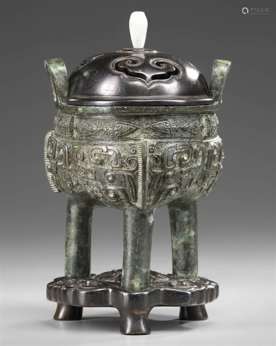 A CHINESE BRONZE RITUAL TRIPOD FOOD VESSEL WITH WOOD COVER A...