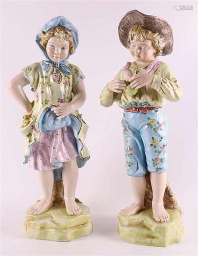 A porcelain girl and boy with apples, Germany, circa 1900.