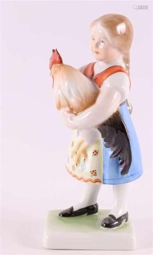 A polychrome porcelain girl with a rooster, Hungary, Herend,...