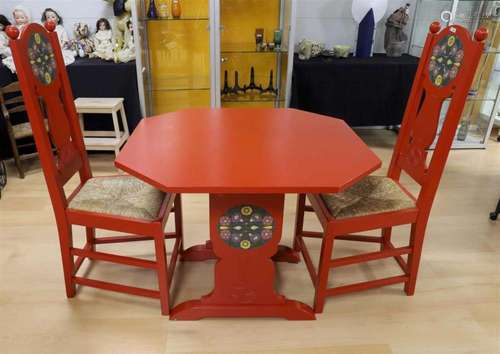 A red lacquered wooden octagonal table with chairs, Heinrich...