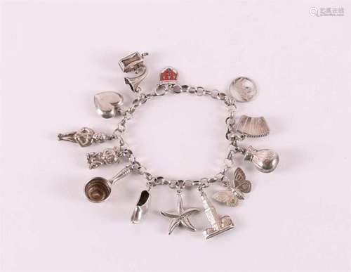 A second grade silver bracelet, jasseron link with many char...