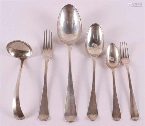 A silver vegetable serving spoon, sauce spoon and two place ...