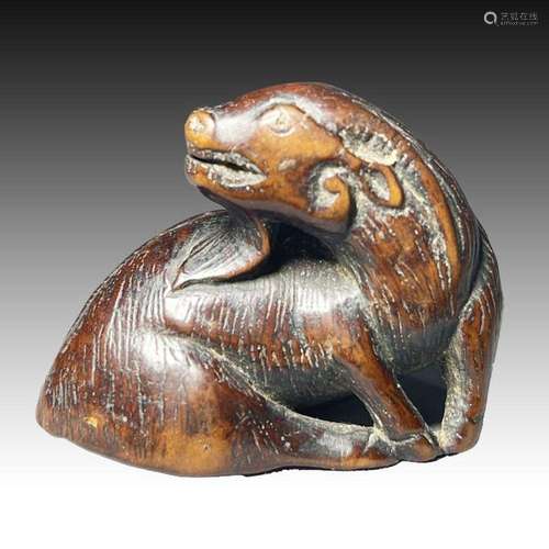 A WOOD NETSUKE OF A GOAT, MEIJI PERIOD