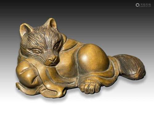 A WOOD NETSUKE OF A TANUKI, MEIJI PERIOD