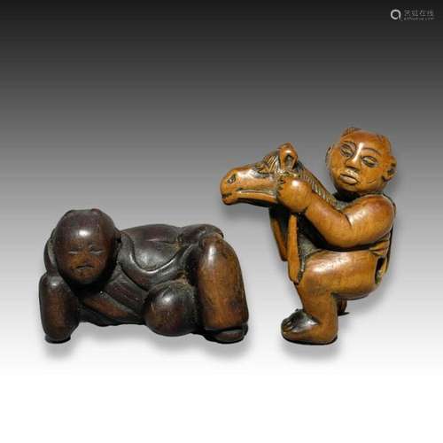 A WOOD NETSUKE OF CHILD ON A ROCKING HORSE & A RECLINING...