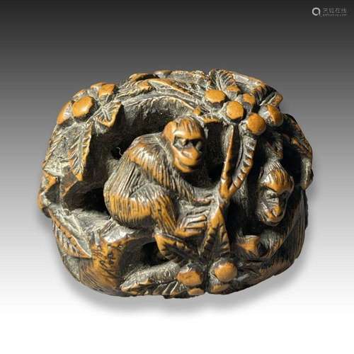 A WOOD NETSUKE OF A MONKEY IN A FOREST, MEIJI PERIOD