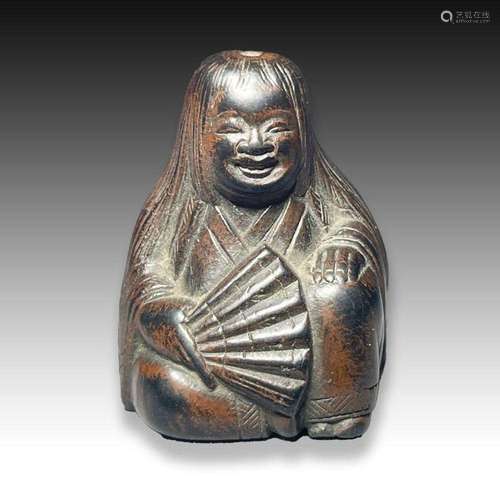 A WOOD NETSUKE OF A SHOJO, MEIJI PERIOD