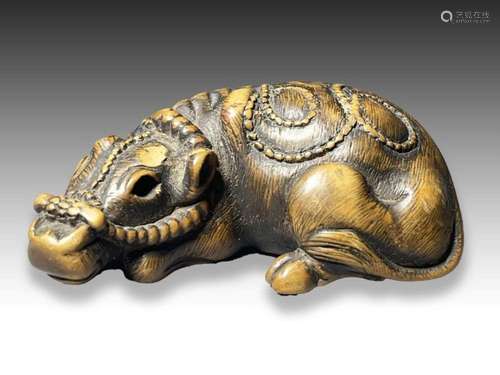 TOMOTADA: A WOOD NETSUKE OF A COW, MEIJI PERIOD