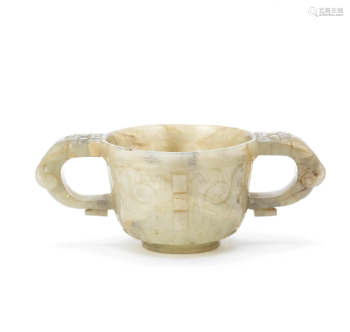 A MOTTLED GREEN JADE ARCHAISTIC TWO-HANDLED CUP Ming Dynasty...