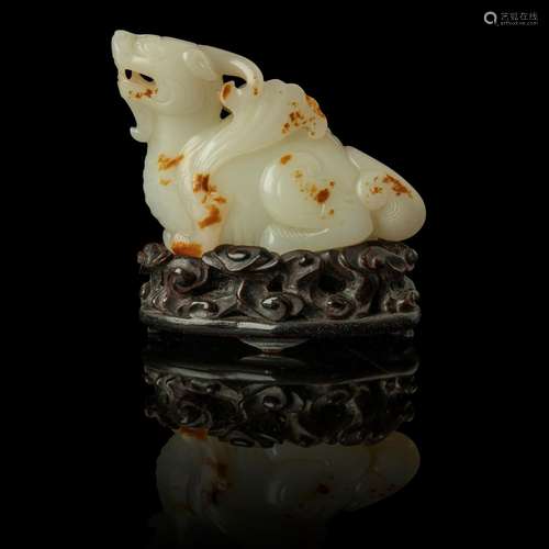 WHITE JADE WITH RUSSET SKIN CARVING OF A MYTHICAL WINGED ANI...