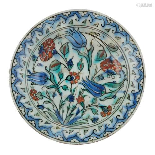 AN IZNIK POTTERY DISH WITH TULIPS, CARNATIONS AND ROSES OTTO...