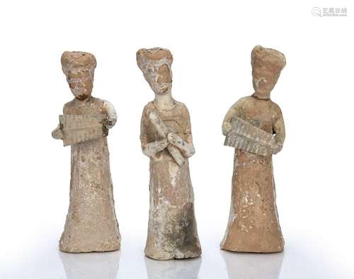 Three unglazed earthenware tomb figures in the form of music...