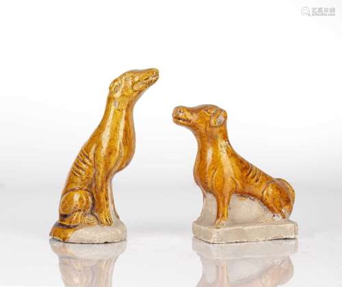 Two yellow glazed tomb figures of dogs