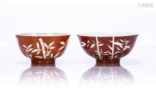 Two similar coral red bowls