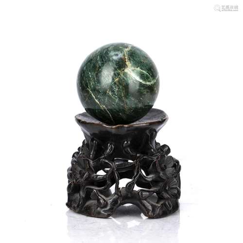 Nephrite jade sphere with a wooden base