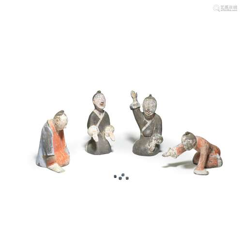 A RARE SET OF FOUR PAINTED POTTERY FIGURES OF GAMBLERS Han D...