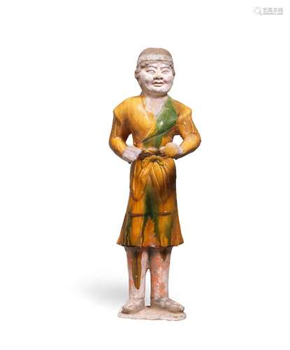 A LARGE SANCAI-GLAZED POTTERY FIGURE OF A GROOM Tang Dynasty...