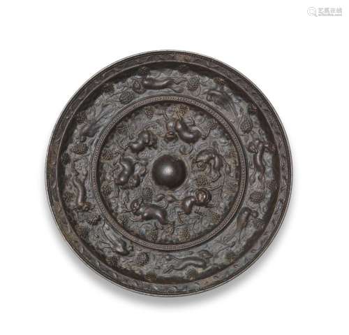 A RARE LARGE BRONZE 'LION AND GRAPEVINE' MIRROR  Tang Dynast...