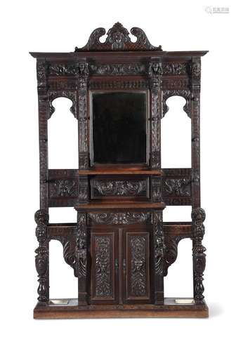 A CARVED OAK HALL STAND IN ANTIQUARIAN TASTE