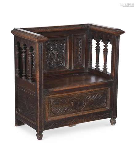 A CARVED OAK HALL SEAT IN ANTIQUARIAN TASTE