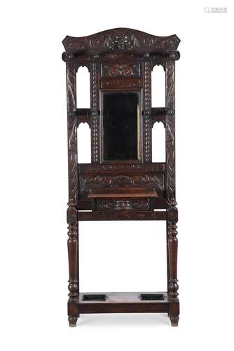 A CARVED OAK HALL STAND IN ANTIQUARIAN TASTE