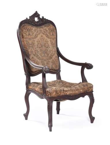 A CARVED OAK OPEN ARMCHAIRIN LOUIS XV STYLE