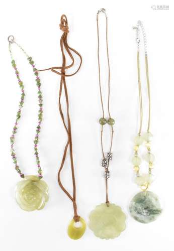 FOUR CARVED GREEN STONE NECKLACES