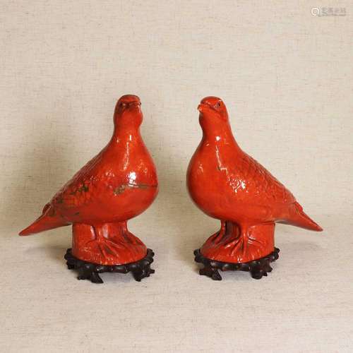 A pair of Chinese export coral-red glazed pigeons,