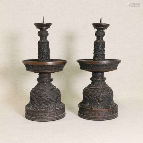 A pair of Chinese cast bronze candlesticks,