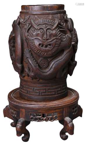 A SOUTHEAST ASIAN CARVED WOOD TOBACCO JAR ON STAND