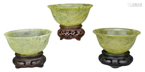 THREE CHINESE 'SPINACH JADE' BOWLS ON STANDS, 20TH CENTURY
