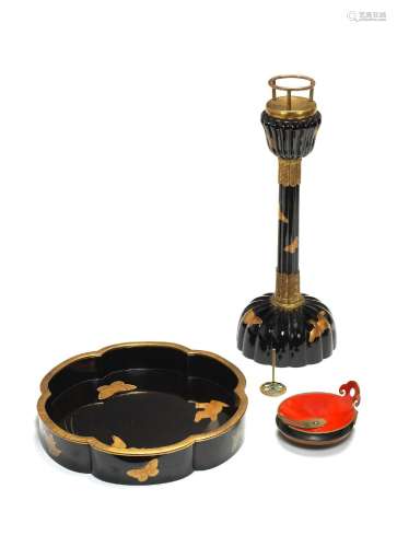 A BLACK-LACQUER MATCHING CANDLESTICK AND TRAY WITH AN OIL DI...