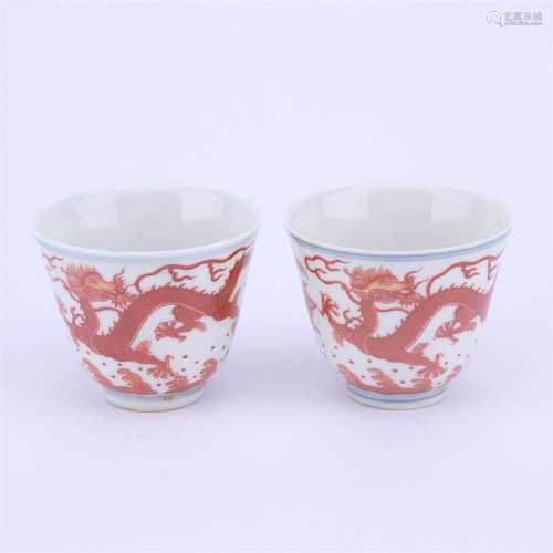 A pair of blue and white iron red dragon porcelain cups