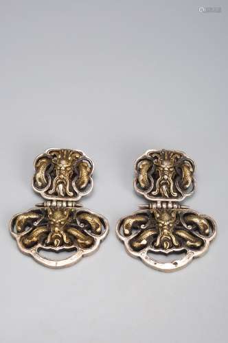 A pair of dragon patterned copper ornaments