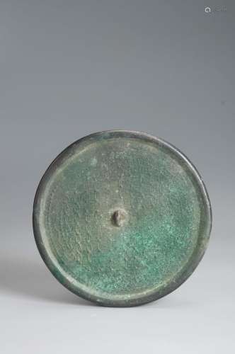 A patterned bronze mirror