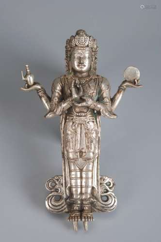 A silver four-armed Guanyin bodhisattva statue