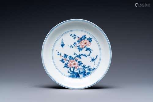 A Chinese blue, white and copper-red saucer dish with floral...