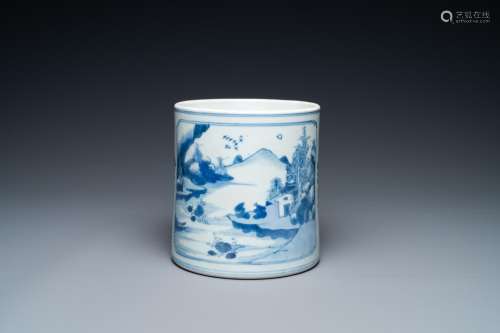 A Chinese blue and white brush pot with a landscape and anti...