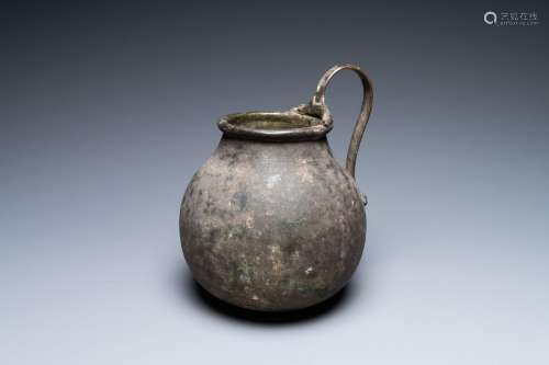 A Roman bronze ewer with a ram's head on the handle's low en...