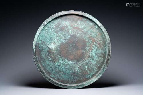 A large Seljuk bronze dish with engraved birds and Kufic ins...