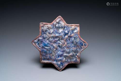 A molded Ilkhanid Lajvardina blue-ground star-shaped tile, I...