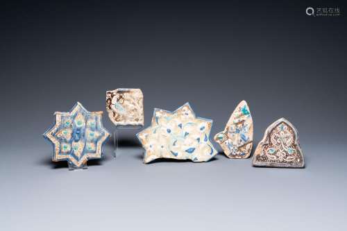 A Kashan star tile and four fragments of luster-glazed tiles...