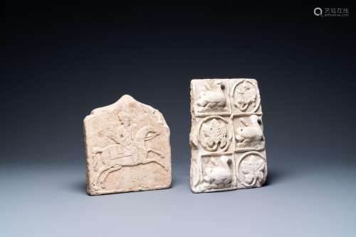 A marble 'horserider' tile fragment and a sandstone fragment...
