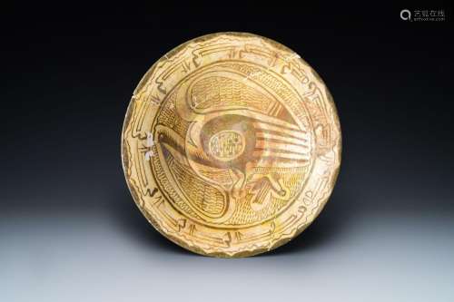 A large Nishapur 'imitation lustre' pottery bowl with a bird...