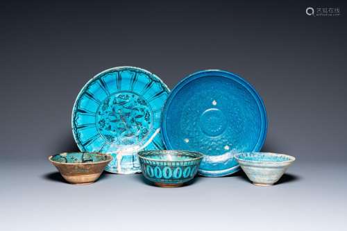 A collection of three turquoise-glazed bowls and two dishes,...