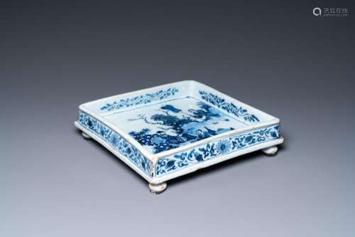A Dutch Delft blue and white square footed tray on ball feet...