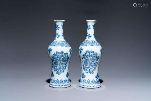 A pair of Dutch Delft blue and white bottle vases with flora...